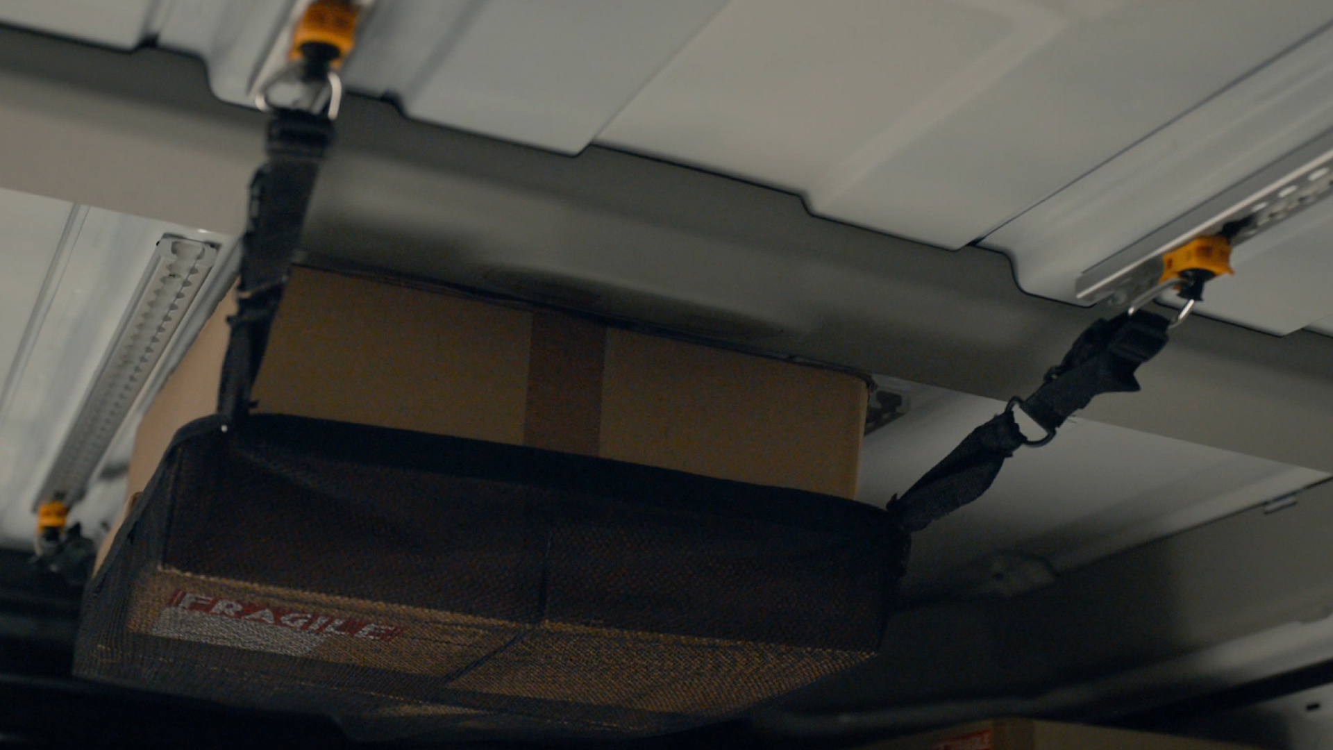 Close-up of Roof-L-Track rail mounted on KIA PV5 cargo wall